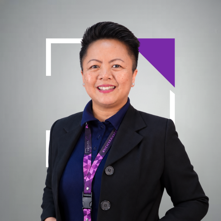 A man wearing a purple shirt that says levera