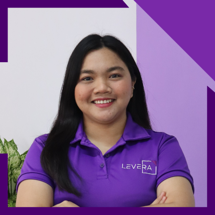 A woman wearing a purple shirt that says levera