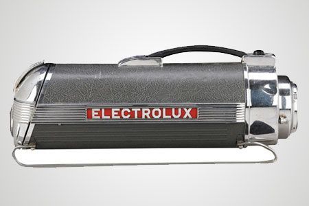 An electrolux vacuum cleaner is sitting on a white surface
