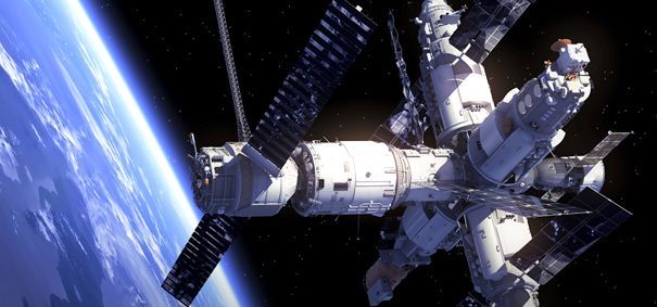 A space station is flying over the earth in space.