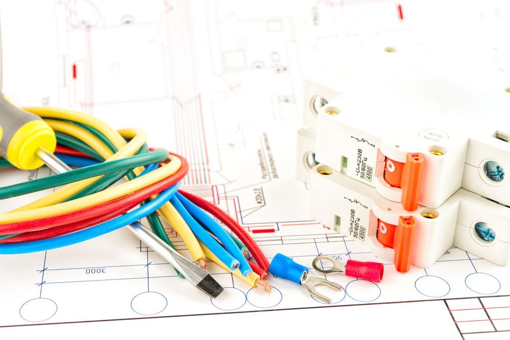 A Bunch Of Electrical Wires And A Screwdriver On Top Of A Drawing — Barcou Electrics In Gordonvale, QLD
