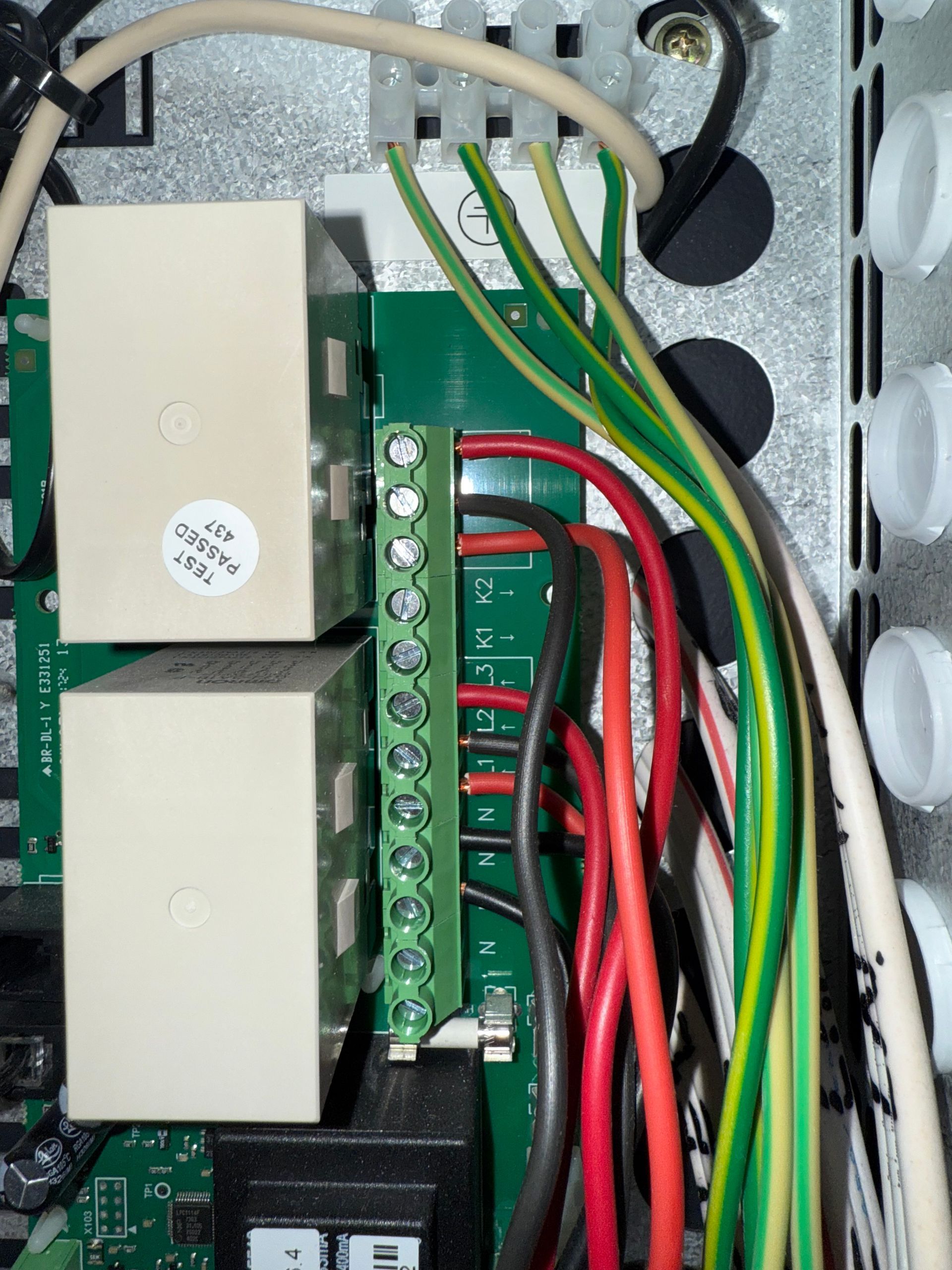 A bunch of wires are connected to a green board — Mylec Electrical Solutions in Shell Cove, NSW