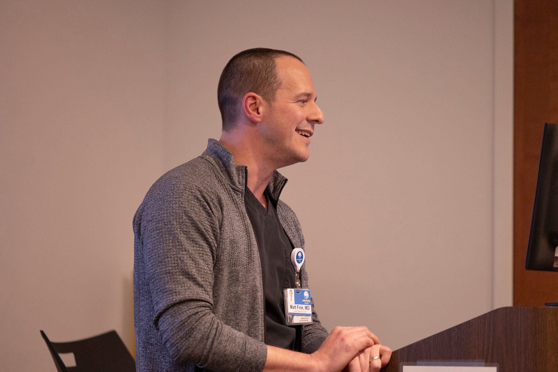 A man is standing at a podium giving a presentation.