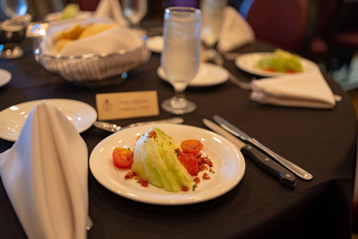 A plate of food is sitting on a table with utensils.
