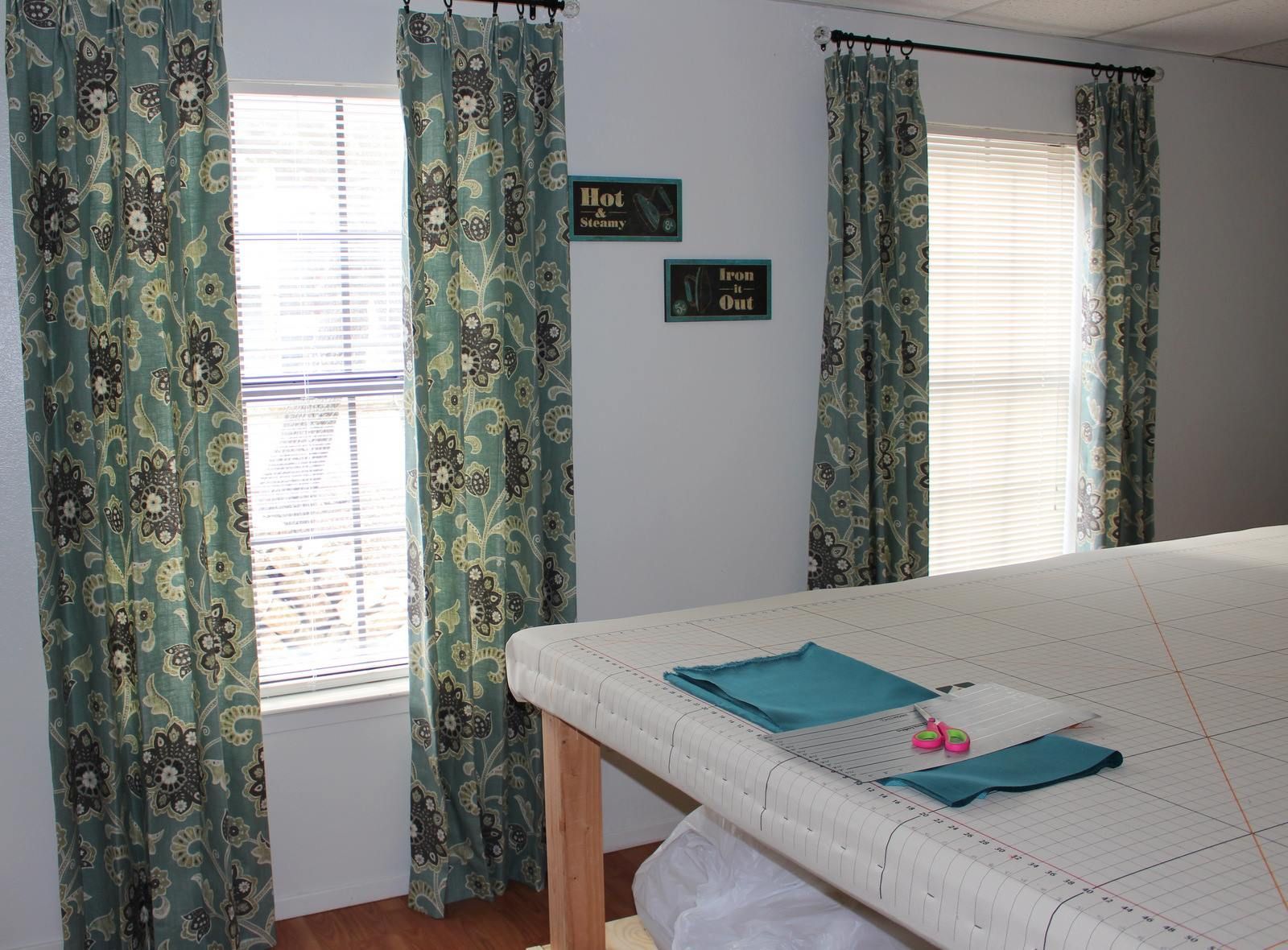 A room with curtains and a sign that says home