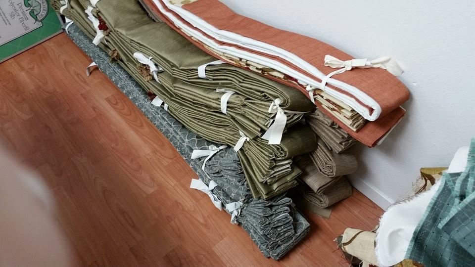 A bunch of ropes are stacked on top of each other on a wooden floor