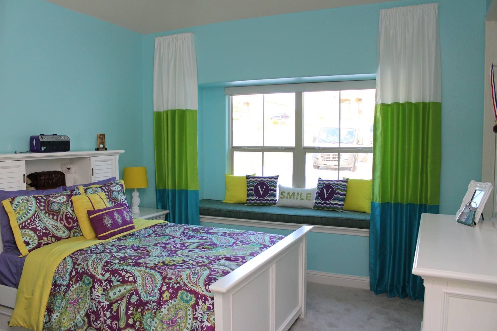 A bedroom with a bed and a window seat
