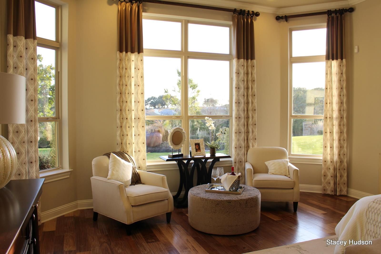 A living room with two chairs and an ottoman