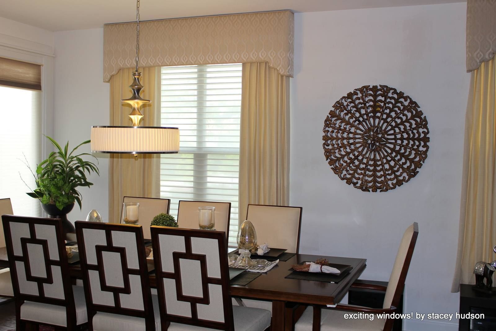 A dining room with a table and chairs and a chandelier