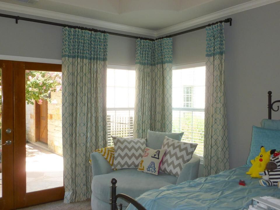 A bedroom with a bed , chair , and sliding glass doors.