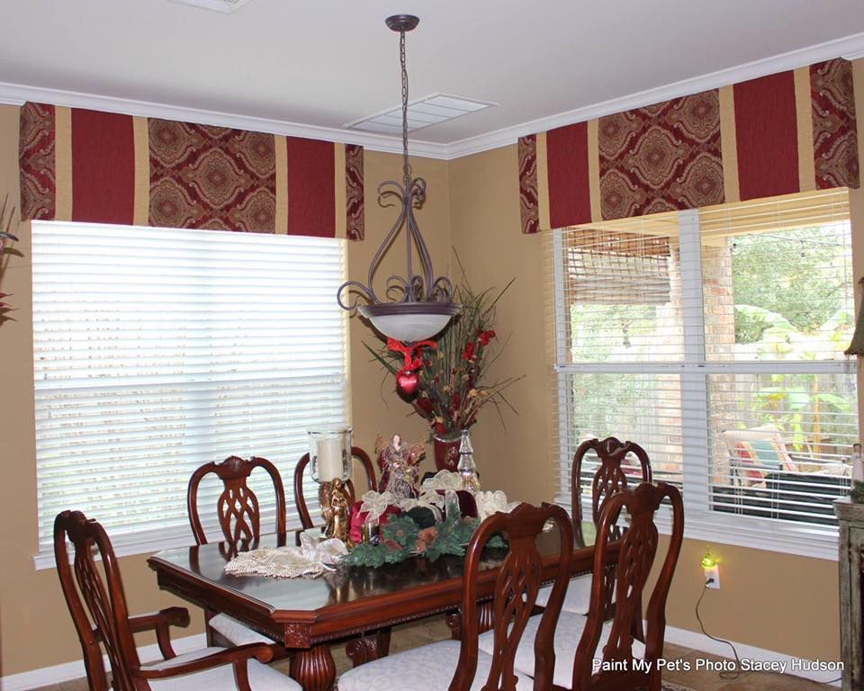 A dining room with a table and chairs and a chandelier