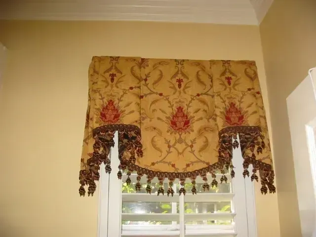 A window with a valance and shutters on it