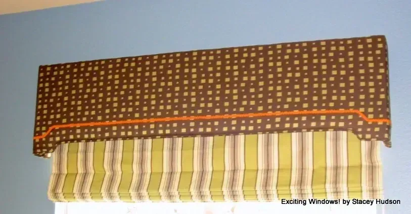 A window with a brown and yellow striped valance