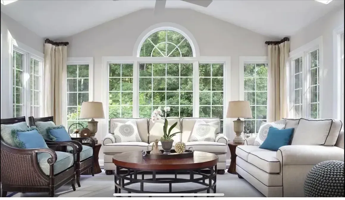 A living room with a lot of windows and furniture