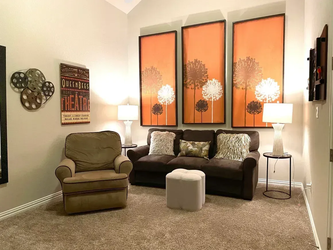A living room with a brown couch and a chair