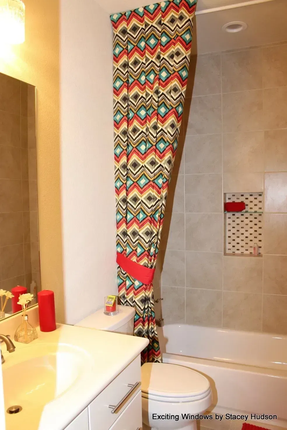 A bathroom with a toilet , sink , shower curtain and bathtub.