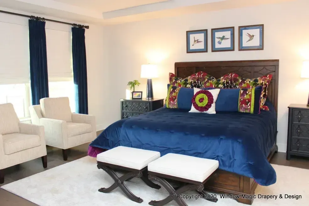 A bedroom with a bed , chairs , dresser and nightstand