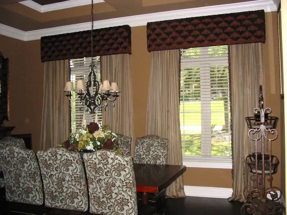 A dining room with a table and chairs and a chandelier