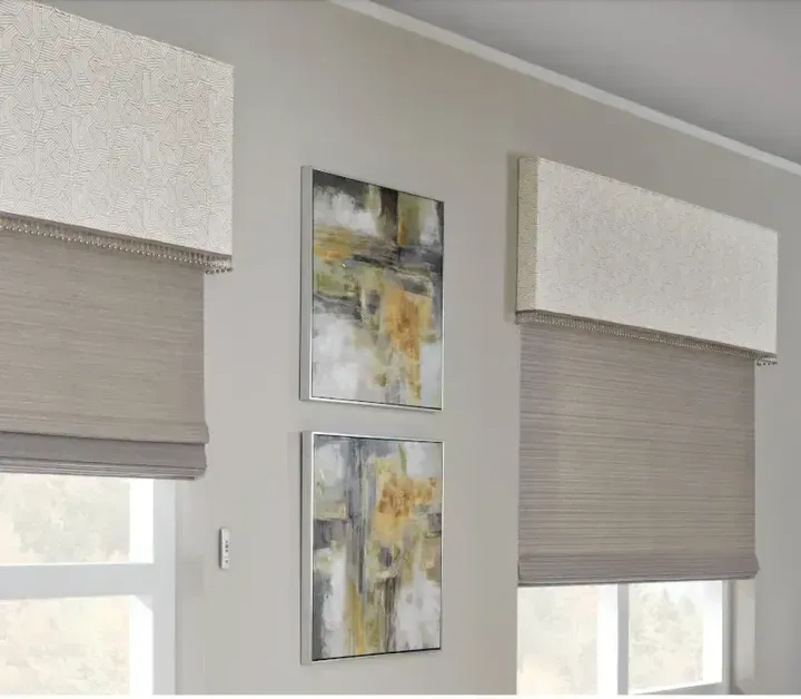 A room with two windows and two paintings on the wall