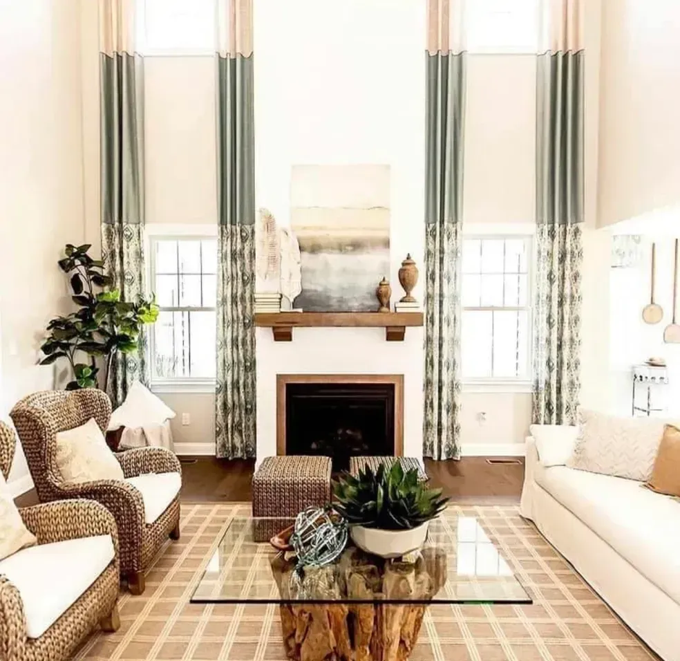 A living room with a couch , chairs , coffee table and fireplace.