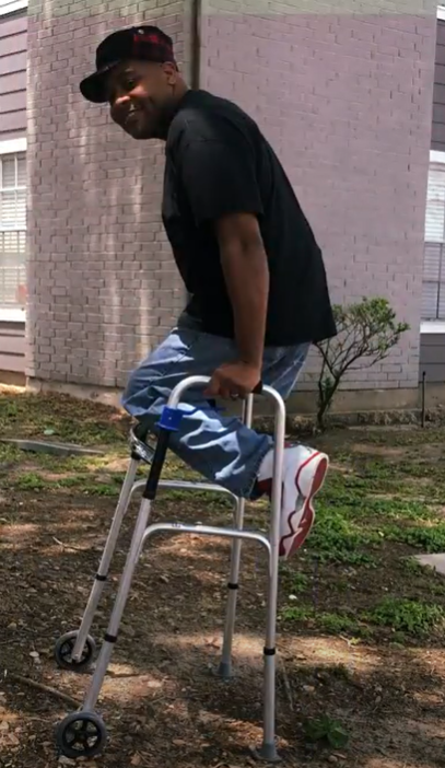 Nijo, an right hip amputee, uses his walker to do a 