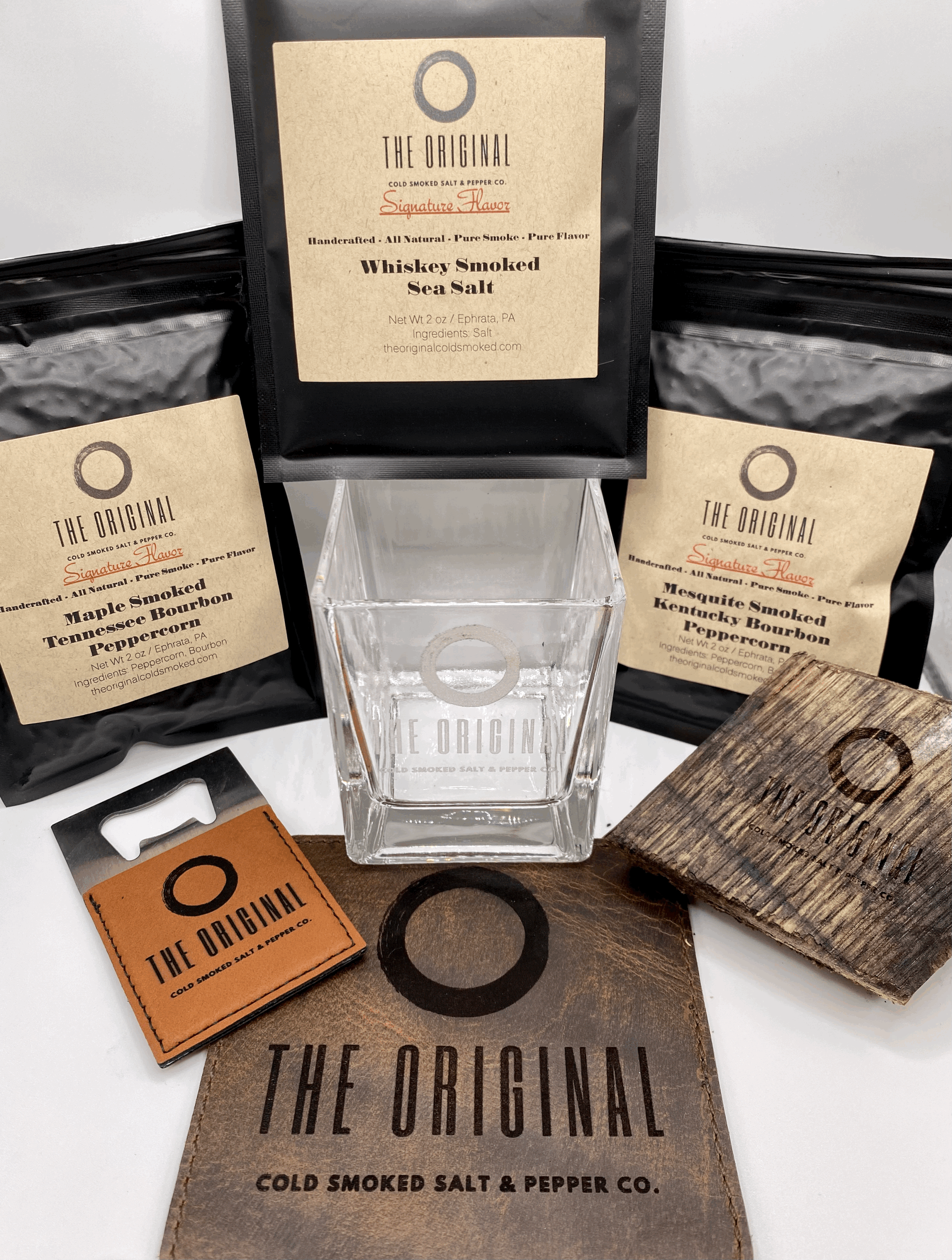 A box filled with a glass , a wallet , and coffee beans.