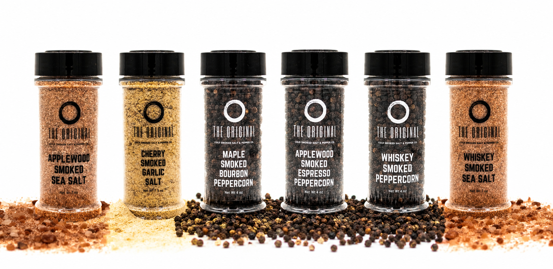 Six coffee cans in brown, gold, and black, surrounded by scattered coffee beans on a white background.