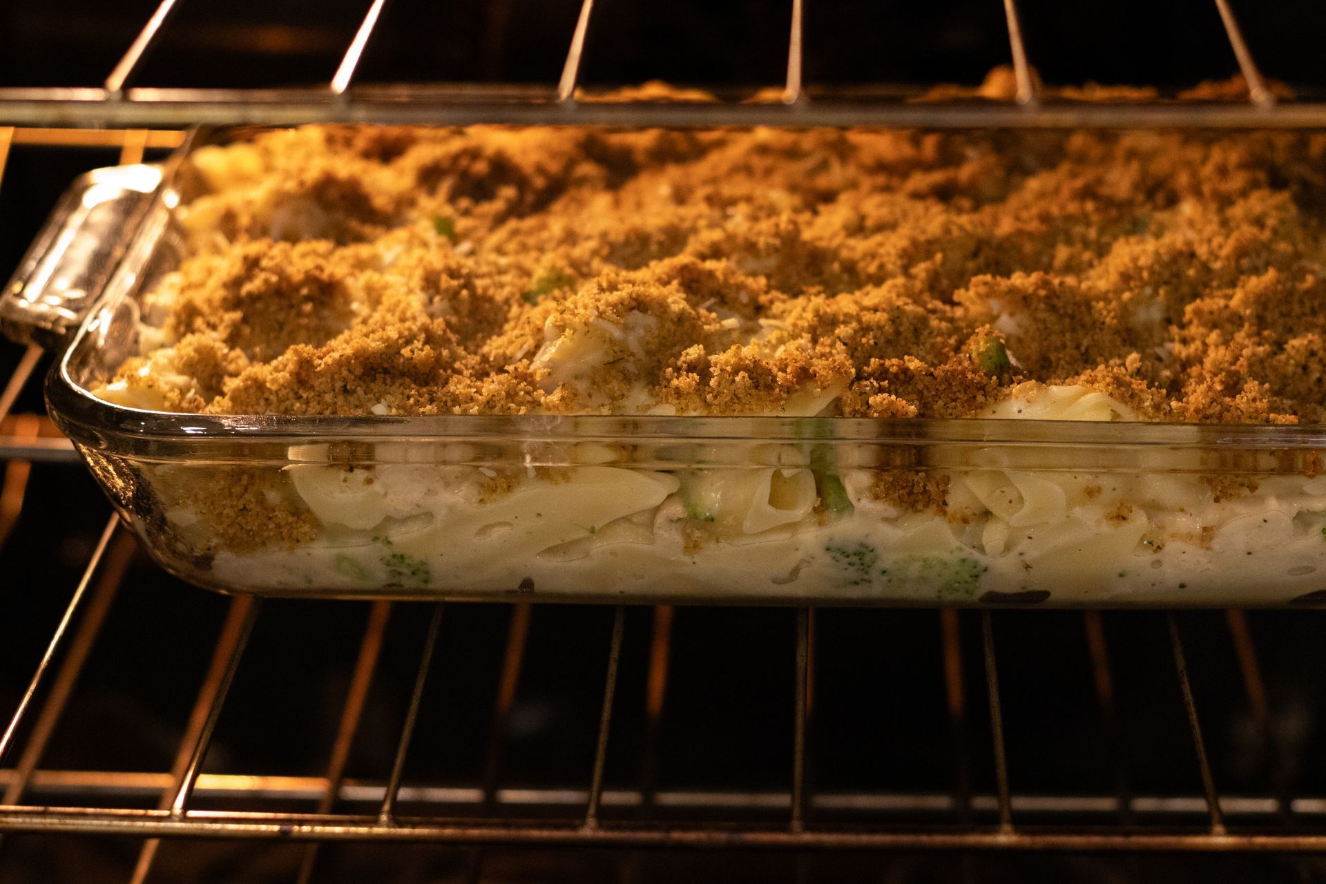A casserole dish is cooking in an oven.