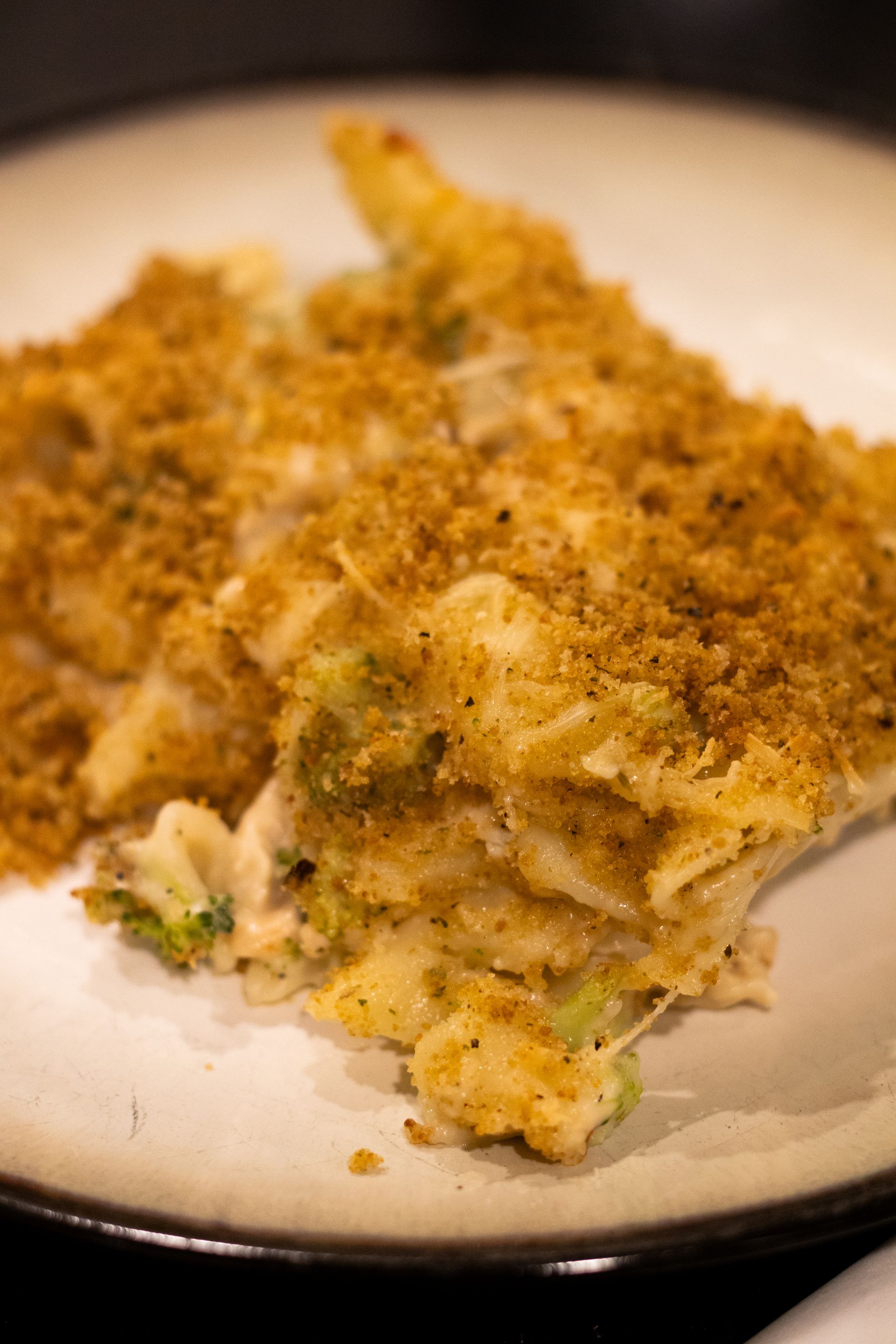 A close up of a piece of macaroni and cheese on a plate.