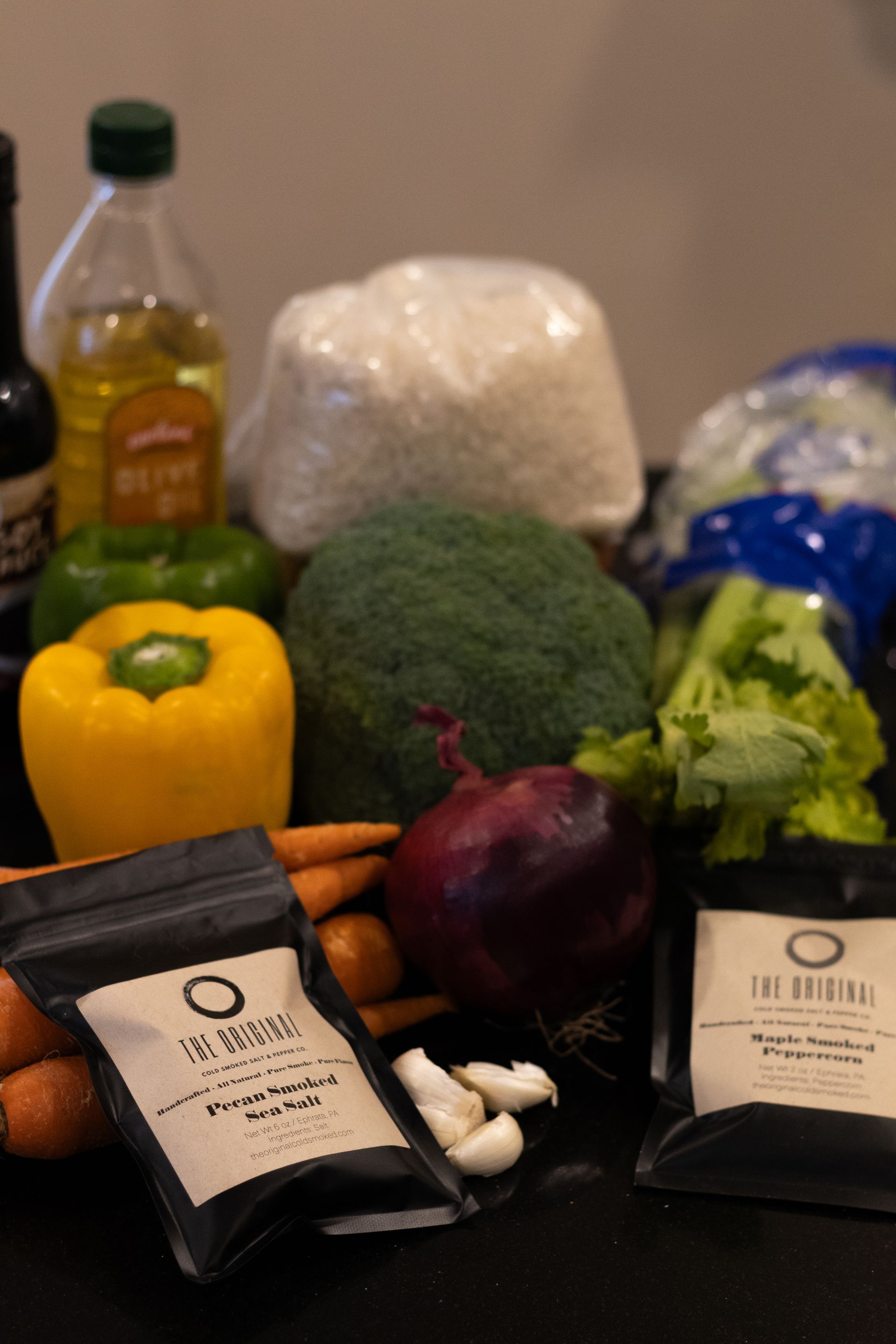 A bunch of vegetables including broccoli carrots and peppers