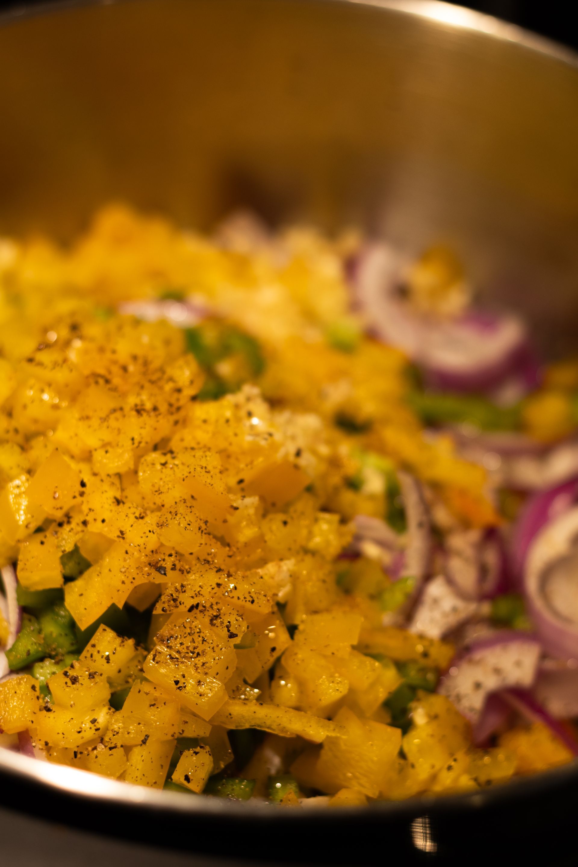 A close up of a pan filled with vegetables on a stove.