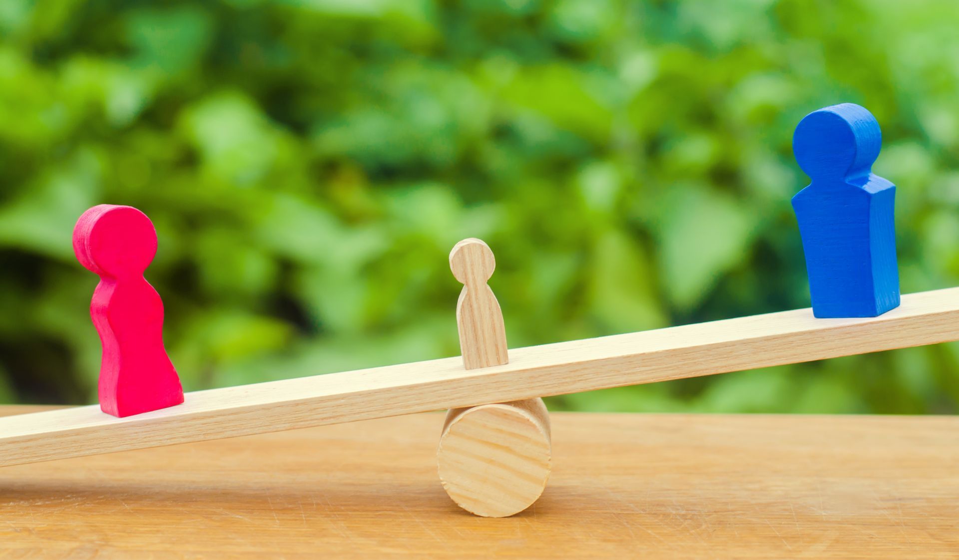 Wooden figures representing the custody of a child.