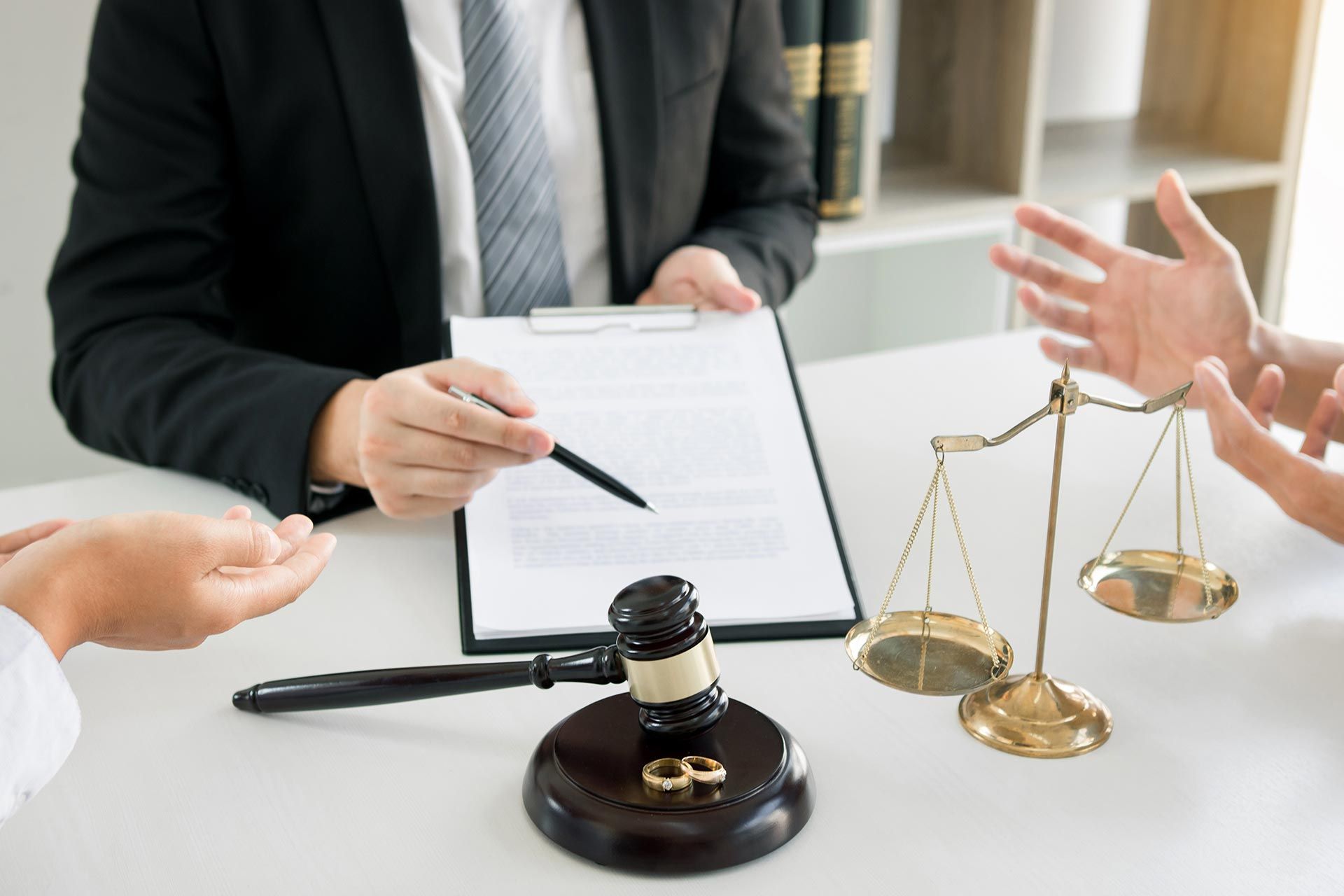 Divorce attorney reviewing documents with a couple at the table