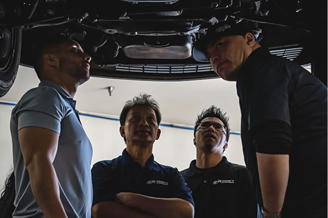 auto repair team working under car | Oscar's Automotive