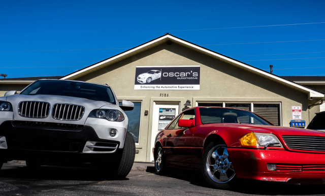 white and red car in front of shop | Oscar's Automotive