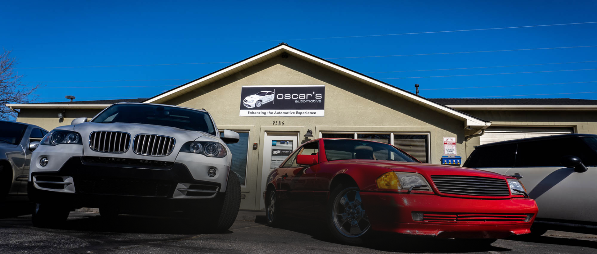 White and Red car in front of shop | Oscar's Automotive