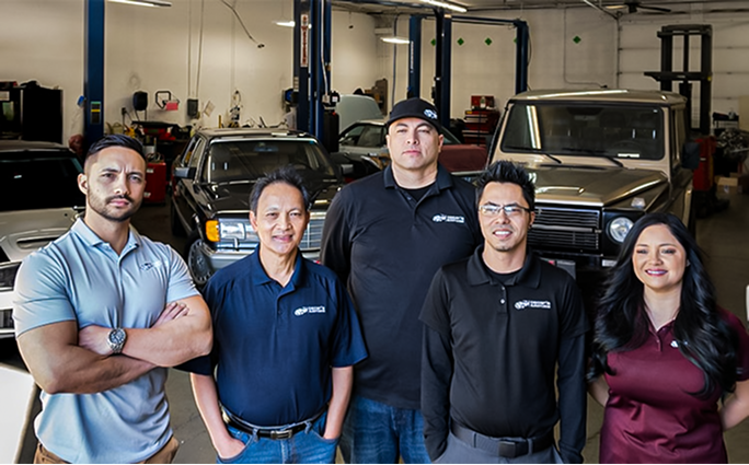 auto repair team standing in garage | Oscar's Automotive