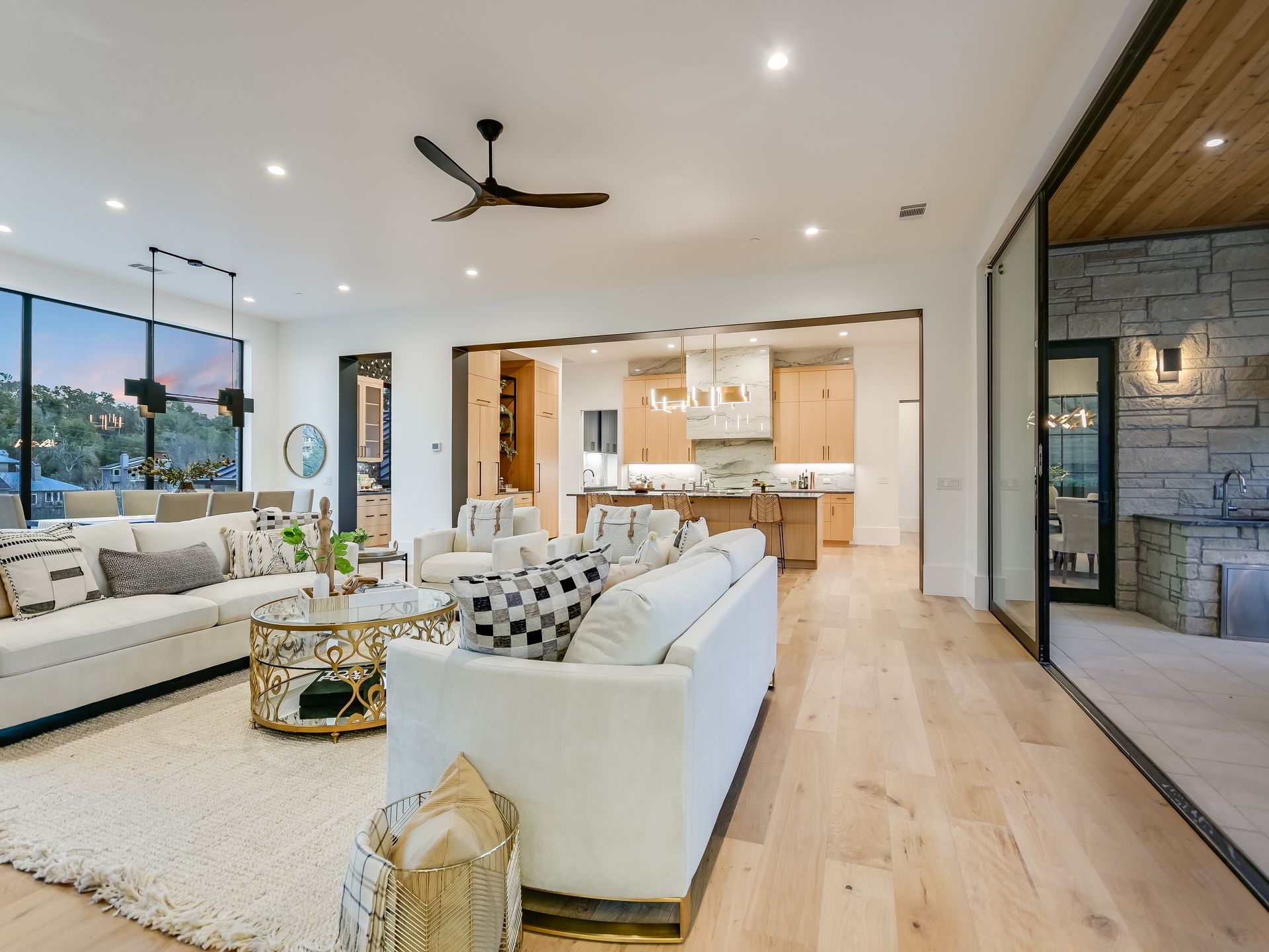 A living room filled with furniture and a ceiling fan.