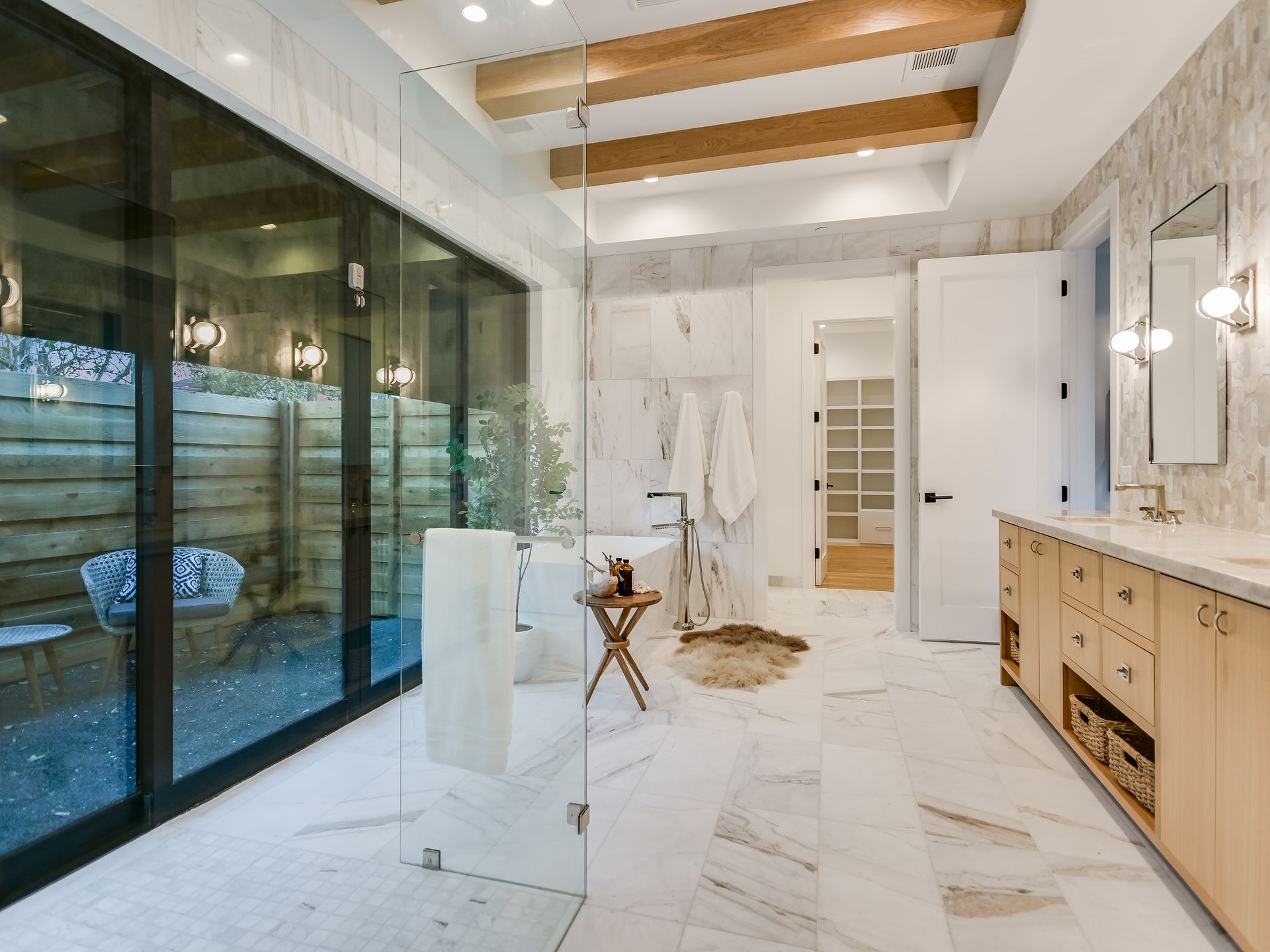 A bathroom with a walk in shower and a sink.