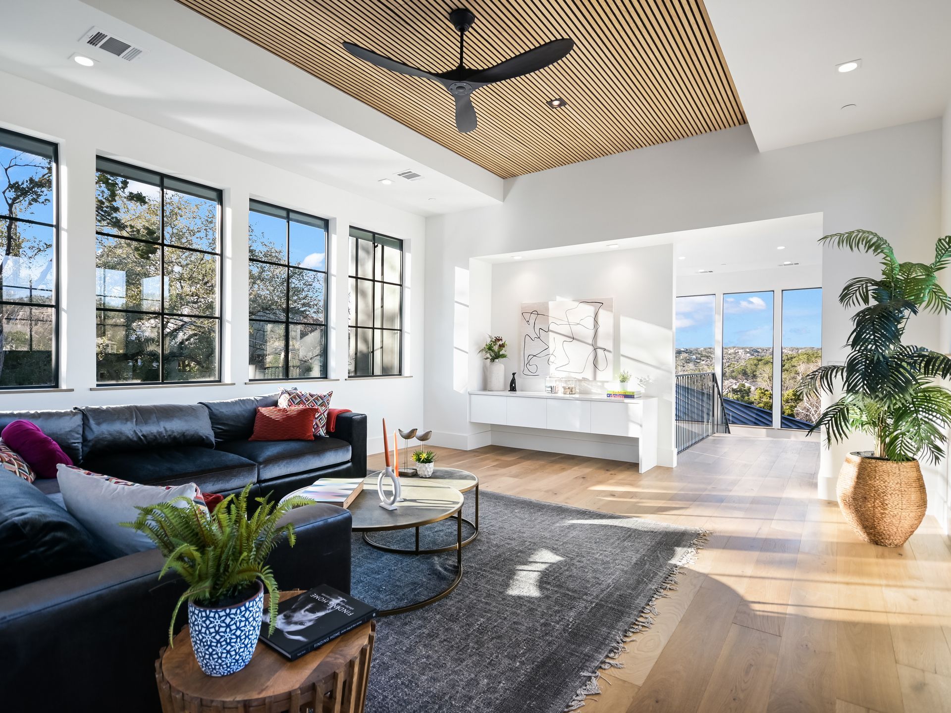 A living room with a couch , table , and ceiling fan.