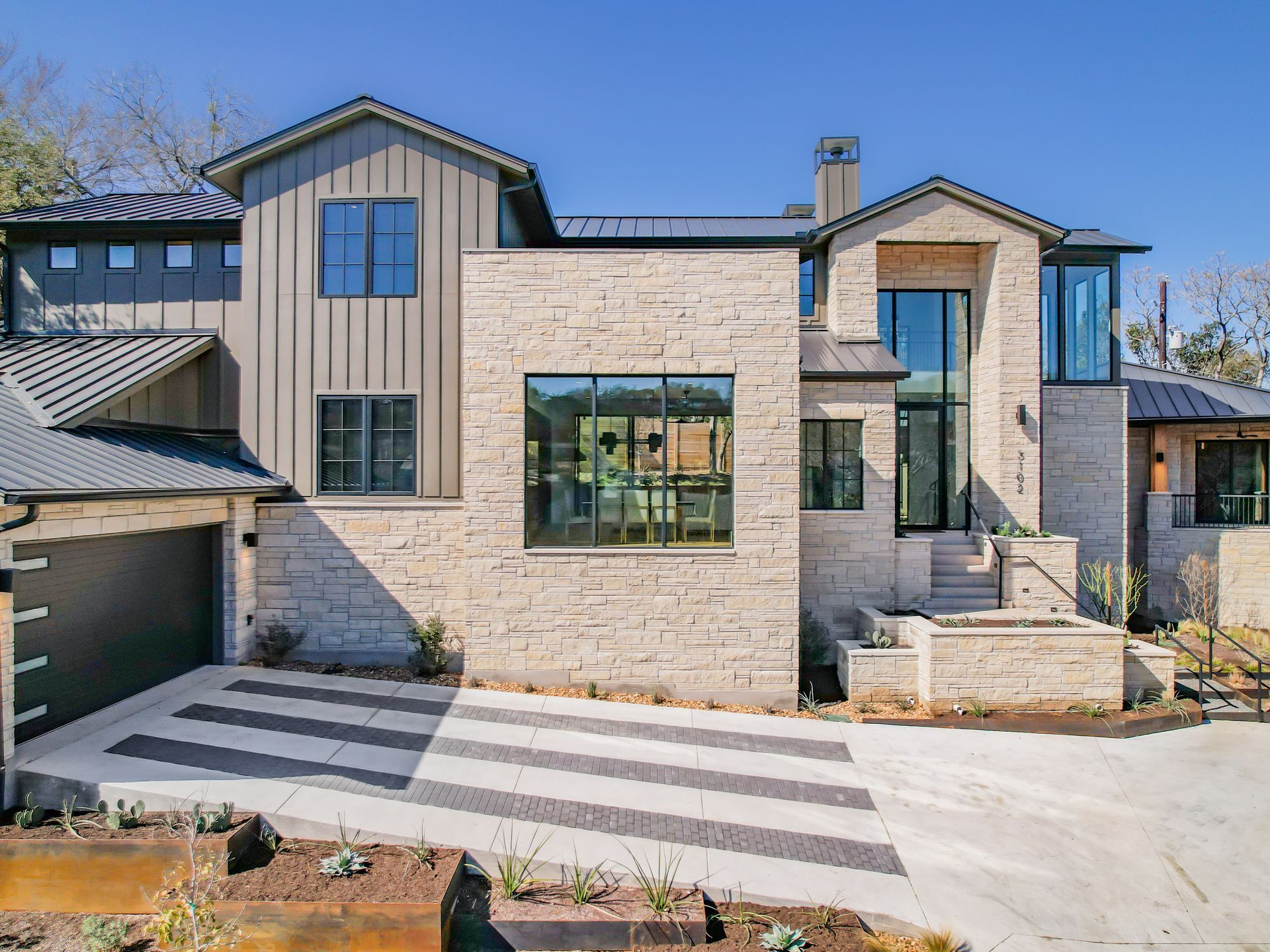 A large brick house with a large driveway and a garage.
