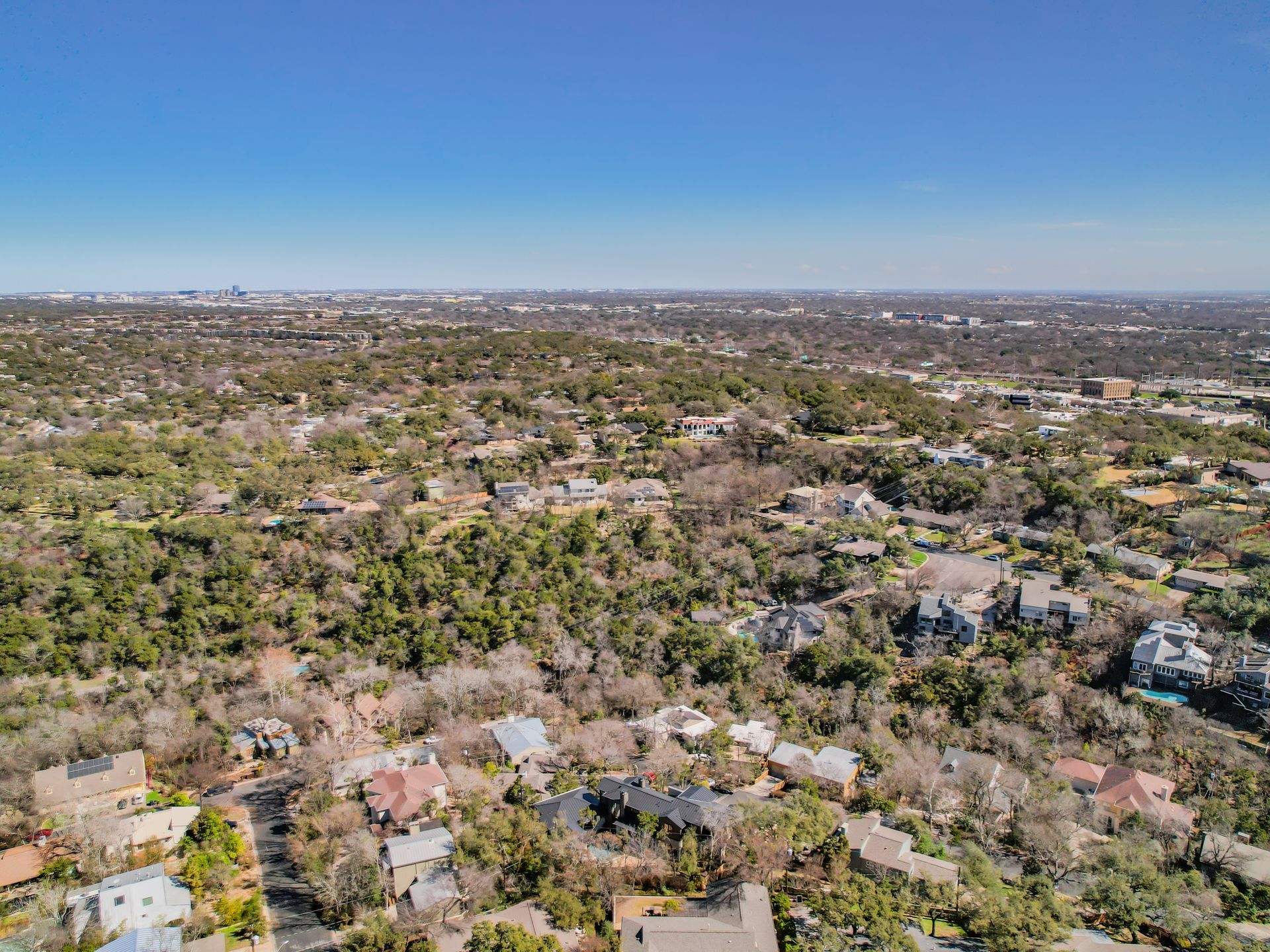 An aerial view of a residential area with lots of trees and houses.
