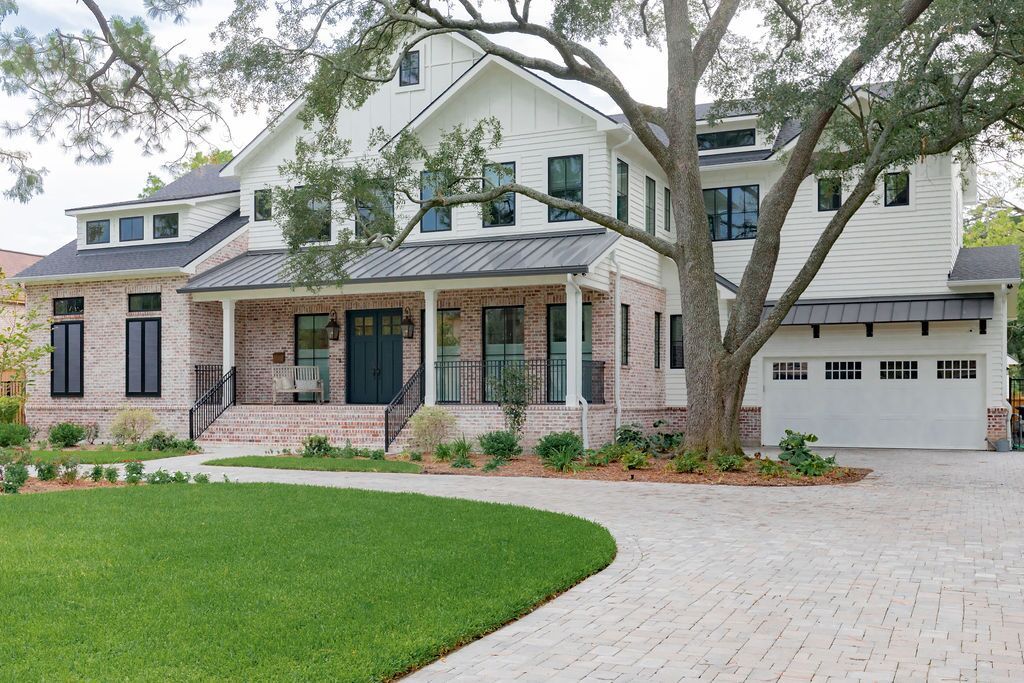 A large white house with a tree in front of it