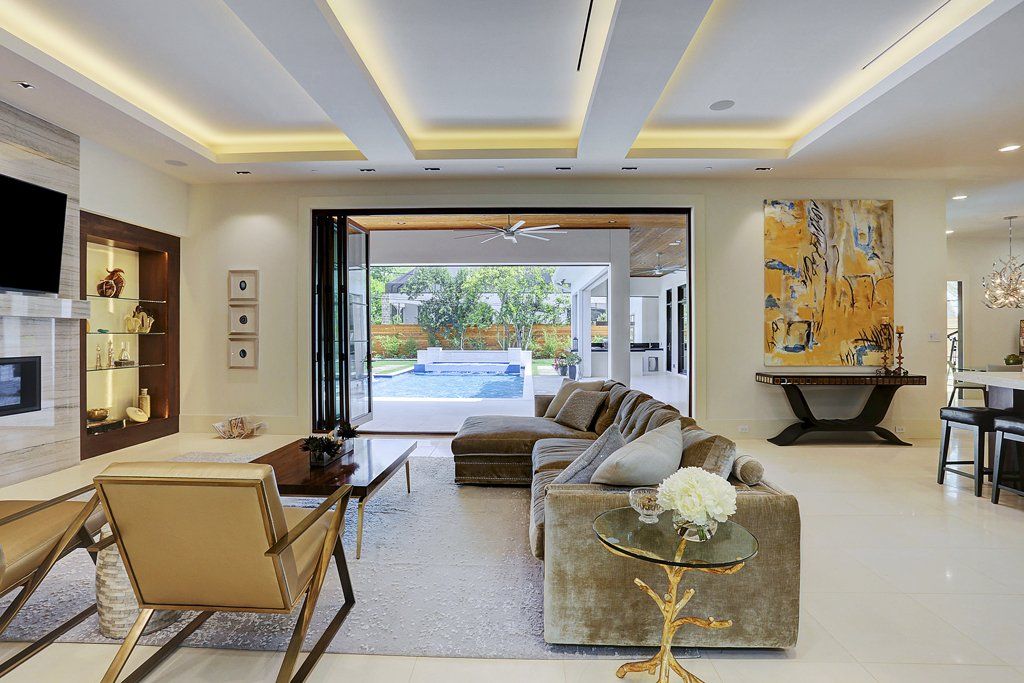 A living room with a couch , chairs , and a table.
