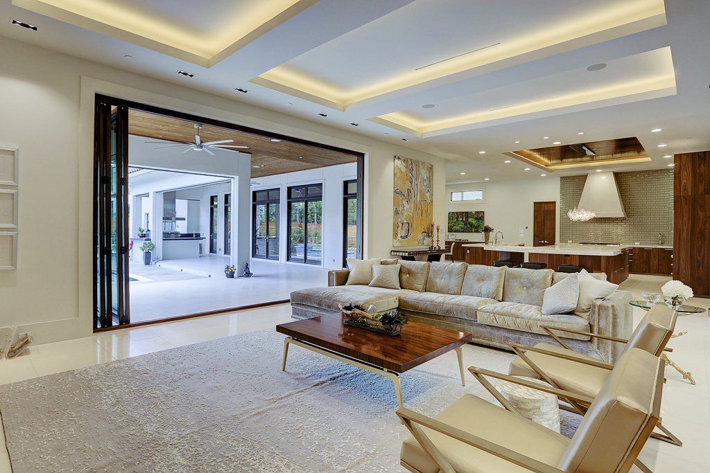 A living room with a couch , chairs and a coffee table.