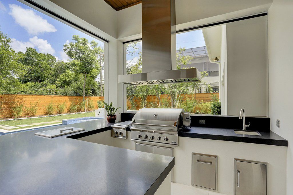 A kitchen with a grill and a large window.