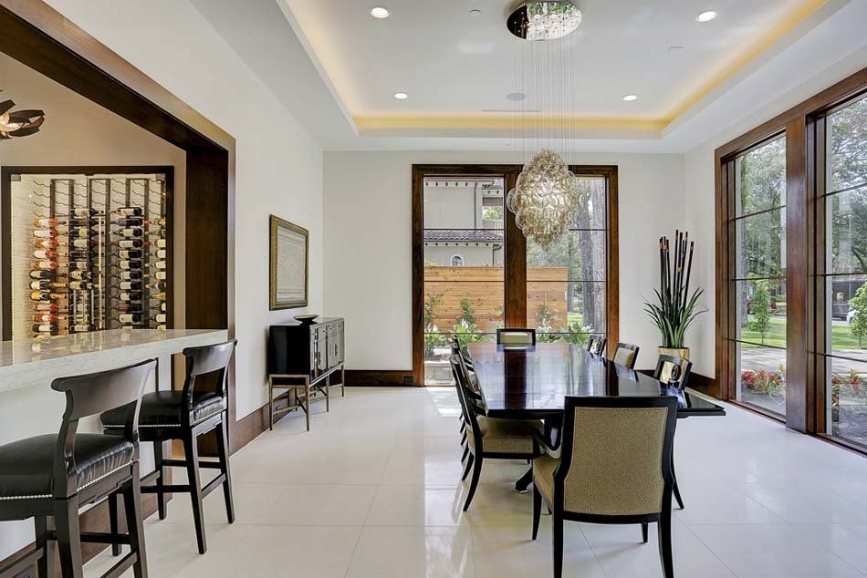 A dining room with a large table and chairs