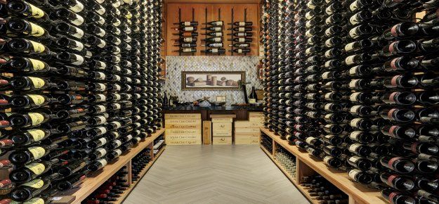 A large wine cellar filled with lots of bottles of wine.