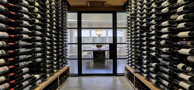 A wine cellar filled with lots of bottles of wine.