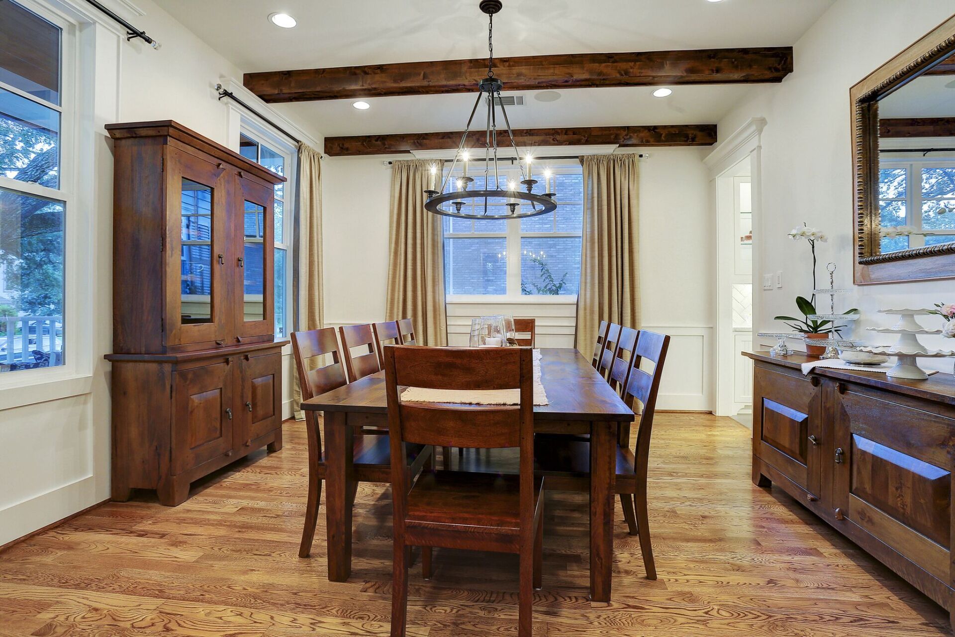 A dining room with a long wooden table and chairs